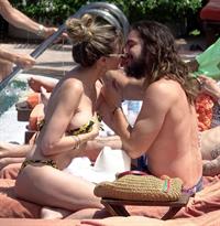 Heidi Klum nip slip in a sexy bikini seen by paparazzi and kissing her husband and flashing her boob.


