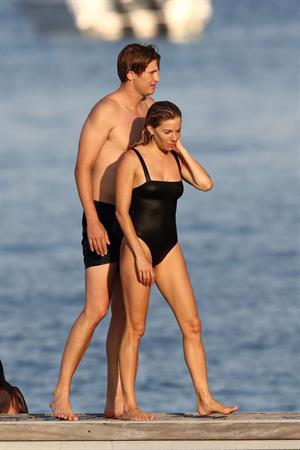 Sienna Miller nip slip wardrobe malfunction boobs popping out of her swimsuit caught by paparazzi.







