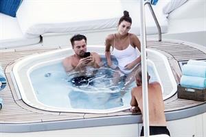 Camila Morrone in a sexy swimsuit in a hot tub on a yacht with Leonardo DiCaprio seen by paparazzi.










