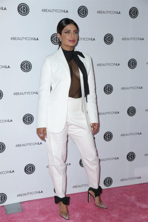 Priyanka Chopra braless boobs in a see through top showing some nice cleavage at Beautycon.

