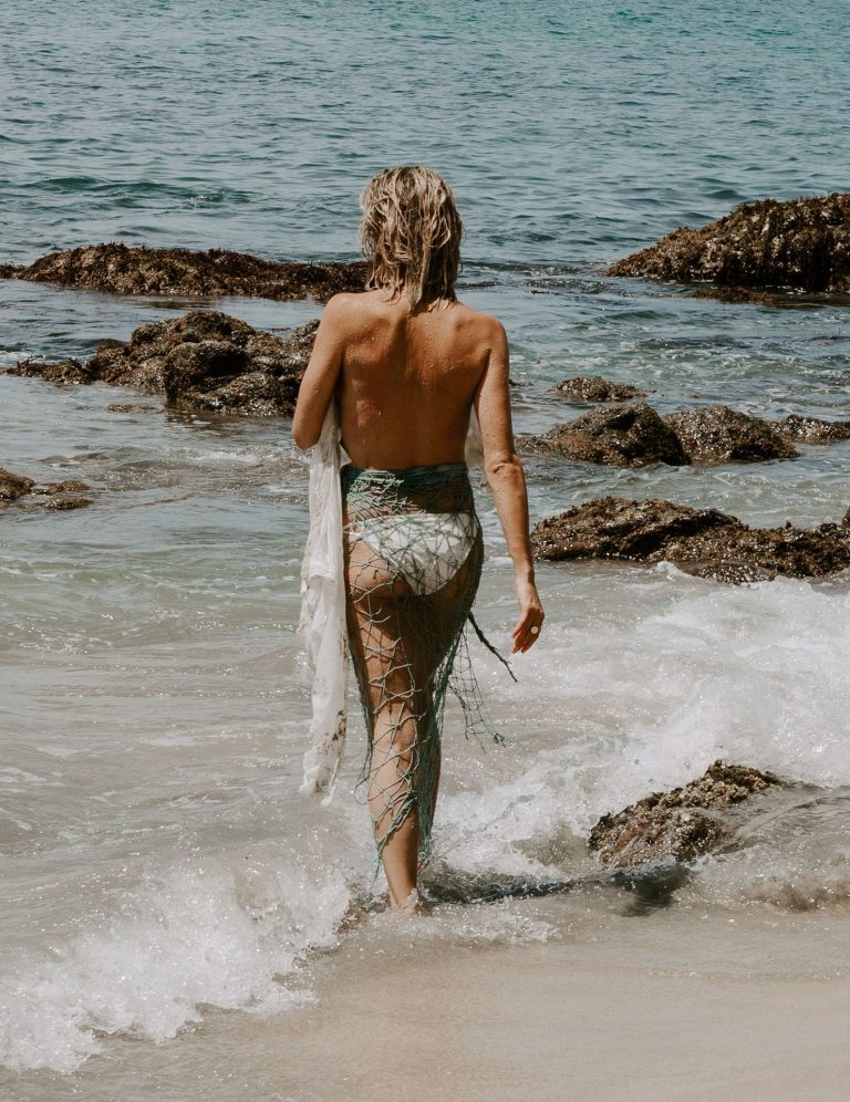 Kristin Cavallari Bikini Pictures Kristin Cavallari topless seen by paparazzi at the beach covering her nude boobs with her arms.
