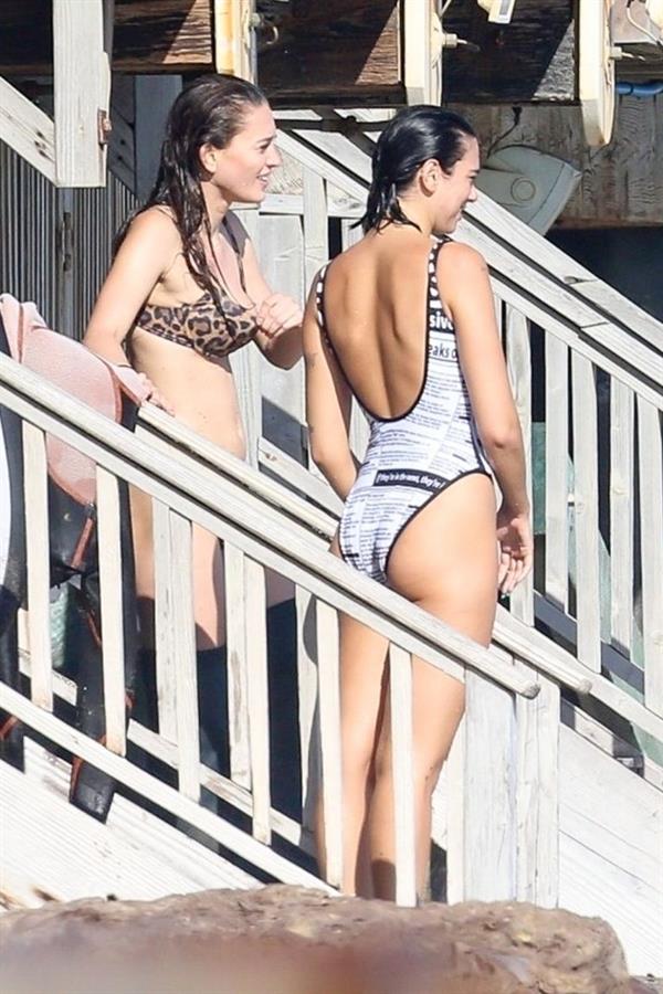 Dua Lipa sexy ass and cleavage in a swimsuit at the beach seen with her boyfriend by paparazzi.













