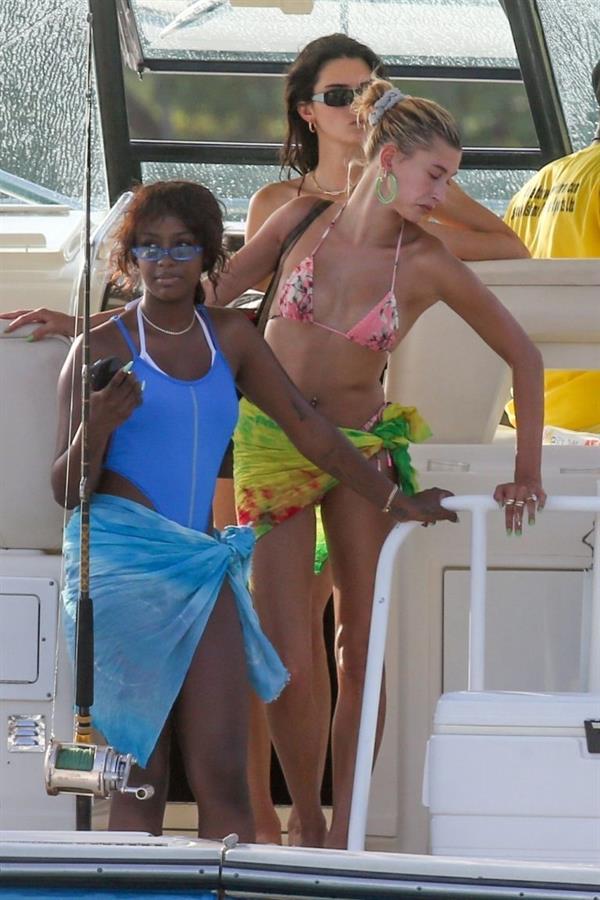 Hailey Bieber, Kendall Jenner and Justine Skye sexy bikini and swimsuit photos seen on a boat drinking for Hailey Bieber's bachelorette party.
