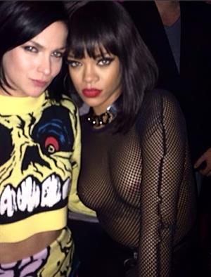 Rihanna Nude Pictures Rihanna braless boobs in a see through fishnet top showing off her tits and pierced nipple.