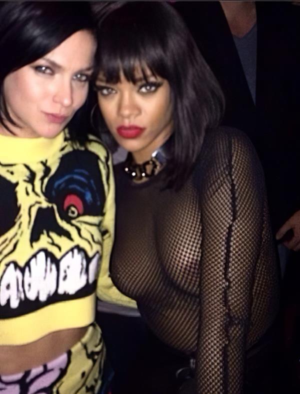 Rihanna braless boobs in a see through fishnet top showing off her tits and pierced nipple.




