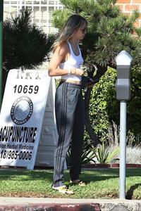 Miley Cyrus braless boobs in a slightly see through white top showing off her tits seen by paparazzi.

