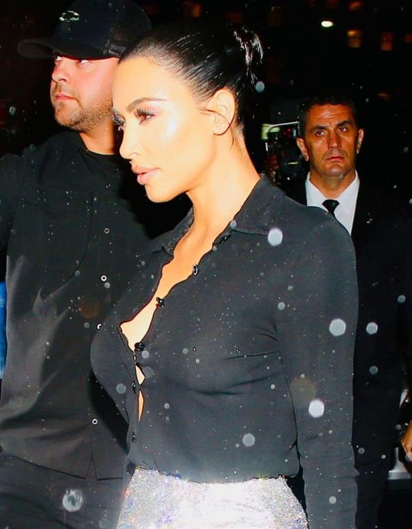 Kim Kardashian braless boobs in a see through black top and mini skirt seen by paparazzi.
























