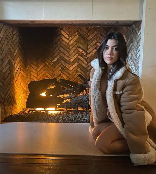 Kourtney Kardashian nude in just a jacket by the fire showing off her braless big tits.