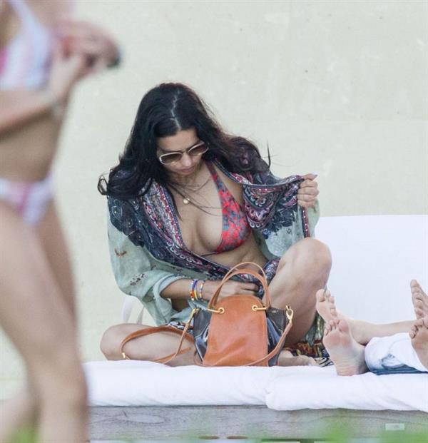 Adriana Lima in a sexy bikini showing nice cleavage with her big tits and ass seen by paparazzi in Miami.