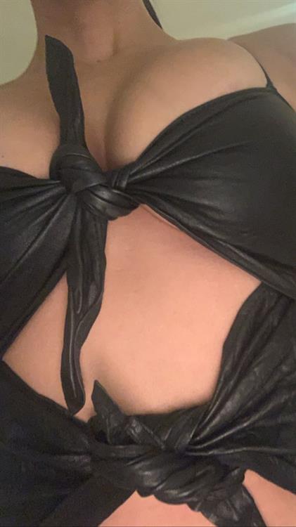 Kourtney Kardashian Pictures Kourtney Kardashian braless boobs in a revealing little black outfit showing nice cleavage closeup with her big tits.