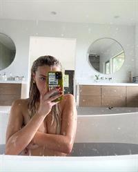 Corinna Kopf new photos taking a selfie naked in the bath holding her nude boobs.