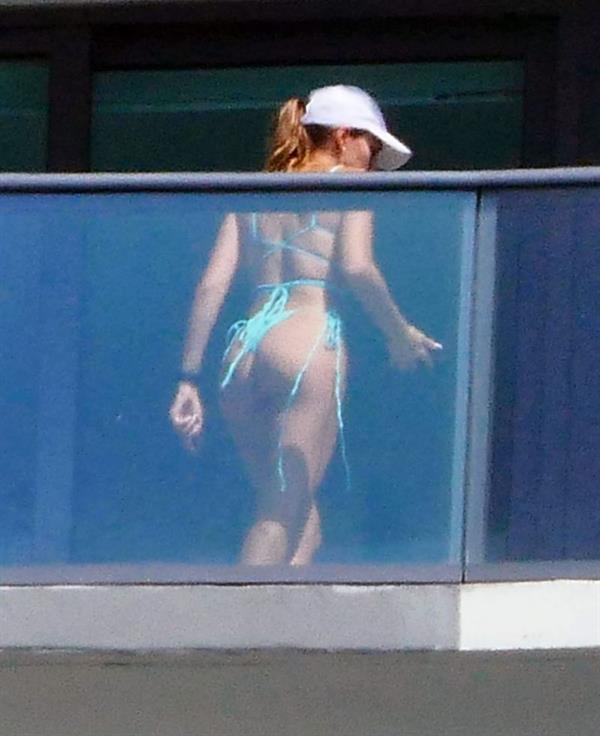 Cindy Prado sexy ass in a thong bikini working out doing squats and stretching on her balcony in Miami during isolation seen by paparazzi.