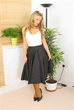  Curly haired blonde in long skirt and satin top 