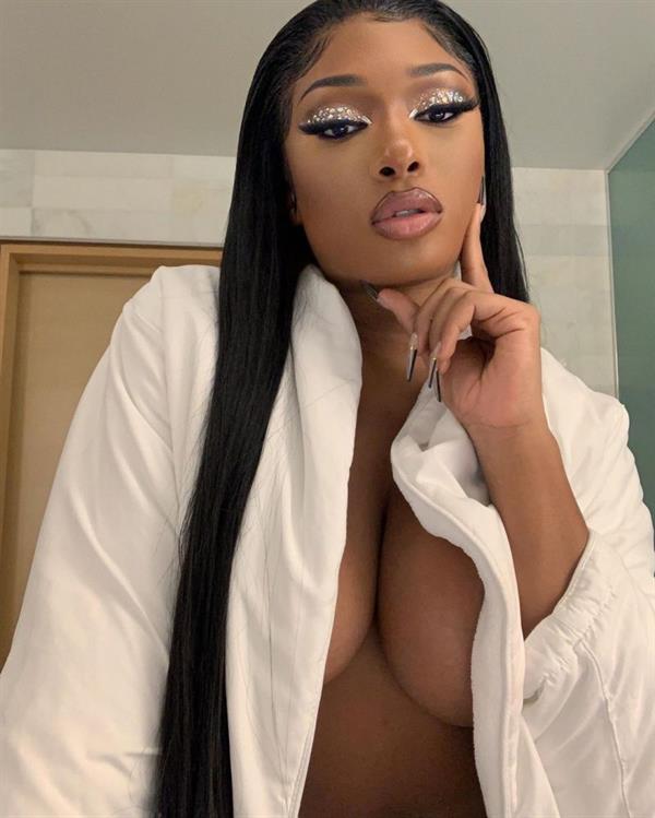 Megan Thee Stallion braless boobs bent over in an open top showing off her big tits cleavage while getting ready.