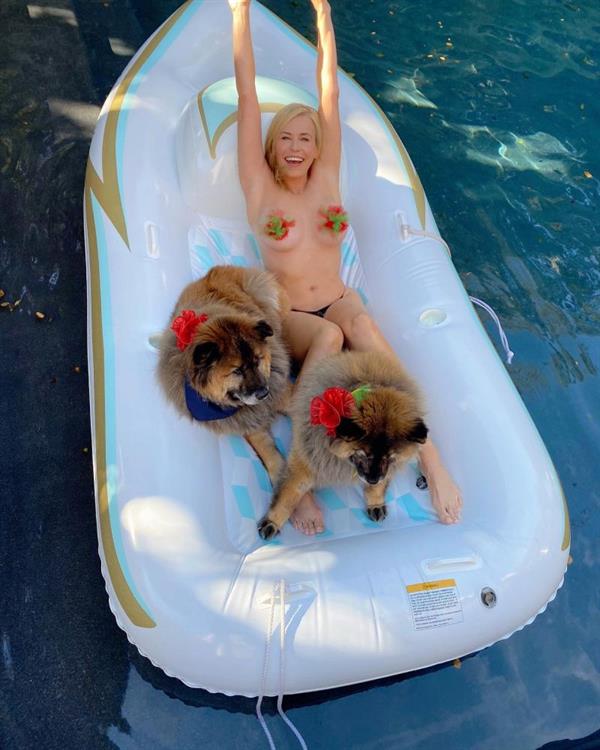 Chelsea Handler topless boobs new photos on a raft in her pool with her dogs showing her nude big tits wearing just thong bikini bottoms.