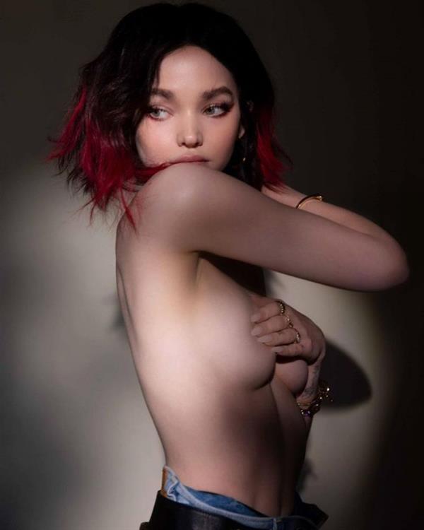 Dove Cameron topless boobs photos from a new photoshoot holding her nude tits with her hand.