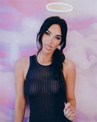Megan Fox braless boobs in a see through black top showing off her big tits very clearly.