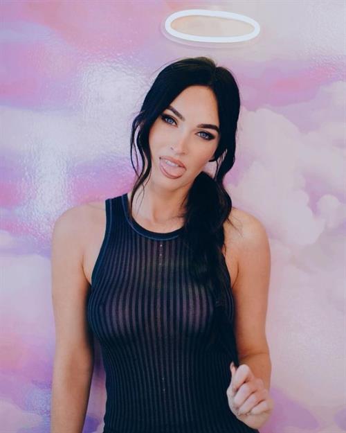 Megan Fox braless boobs in a see through black top showing off her big tits very clearly.