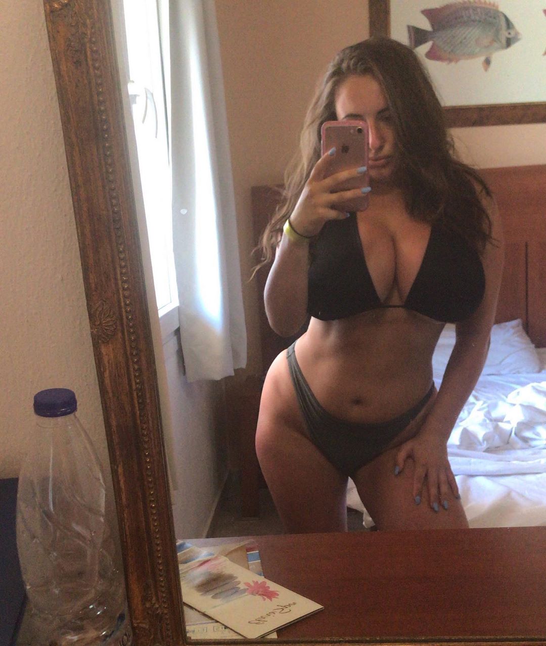 Tiffany Harrison in a bikini taking a selfie