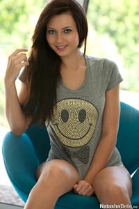Natasha Belle in a smiley face shirt and white lingerie