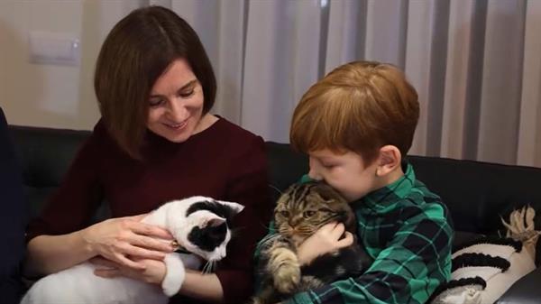 Maia Sandu, the president of Moldova, pets a cat at her mother's house
