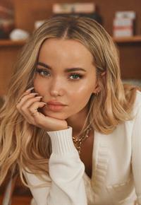 Dove Cameron, born Chloe Celeste Hosterman on January 15, 1996, in Bainbridge Island, Washington, is an American actress and singer who gained fame for her dual role as Liv and Maddie Rooney on Disney Channel's Liv and Maddie (2013–2017), earning her a Daytime Emmy Award. She further solidified her Disney stardom portraying Mal, the daughter of Maleficent, in the Descendants film series (2015–2021). Transitioning into music, Cameron released her debut EP, Alchemical: Volume 1, in December 2023, featuring the hit single  Boyfriend,  which achieved top-20 status on the Billboard Hot 100 and was certified double platinum. Her music, characterized by pop and goth-pop elements, reflects themes of love, grief, and self-reflection. Beyond her entertainment career, Cameron is an advocate for LGBTQ+ rights and mental health awareness, openly discussing her own experiences to inspire and support others.