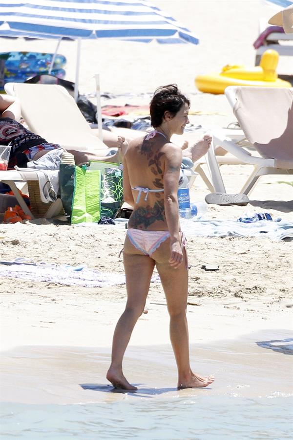 Lena Headey in a bikini - ass